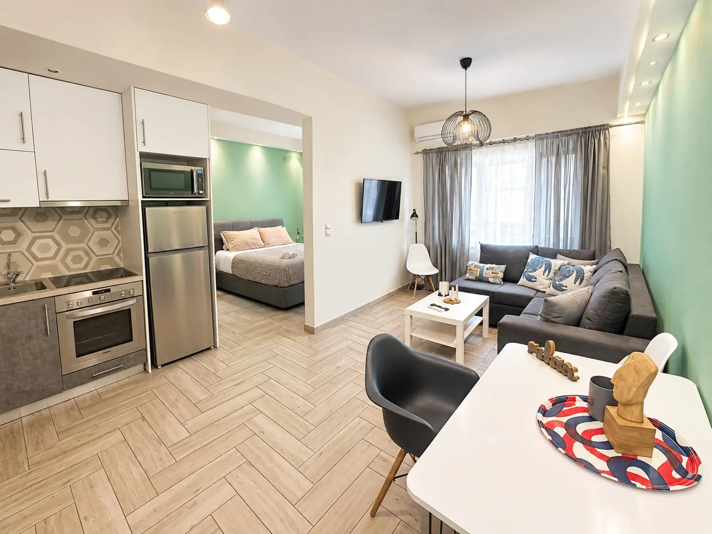 Agatha 2: open-plan living room with kitchen, sofa, dining table and bed